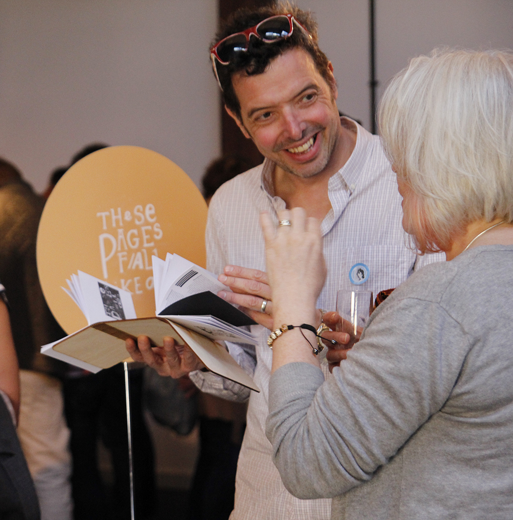 Attendees enjoying 'these pages fall like ash'